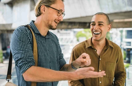 two people talking and laughing