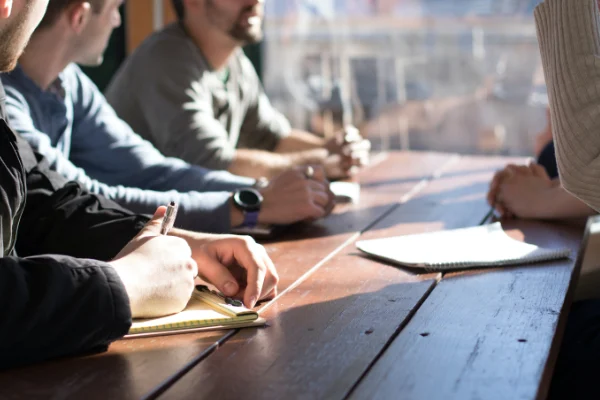 people taking a notes at a desk