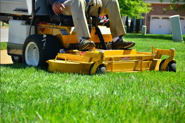 person riding a lawn mower